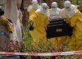 A-woman-cries-as-Red-Cross-workers-carry-the-coffin-of-a-person-who-died-of-Ebola-from-a-health-center-in-Rwampara-Congo-Wednesday-May-20-2026.