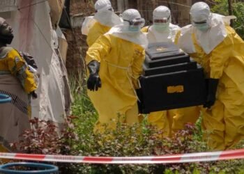 A-woman-cries-as-Red-Cross-workers-carry-the-coffin-of-a-person-who-died-of-Ebola-from-a-health-center-in-Rwampara-Congo-Wednesday-May-20-2026.