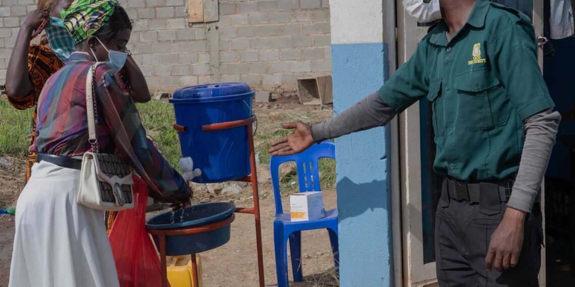 People-wash-their hands-at-the-entrance-to-a hospital-in-Bunia