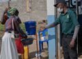 People-wash-their hands-at-the-entrance-to-a hospital-in-Bunia