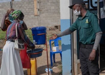 People-wash-their hands-at-the-entrance-to-a hospital-in-Bunia