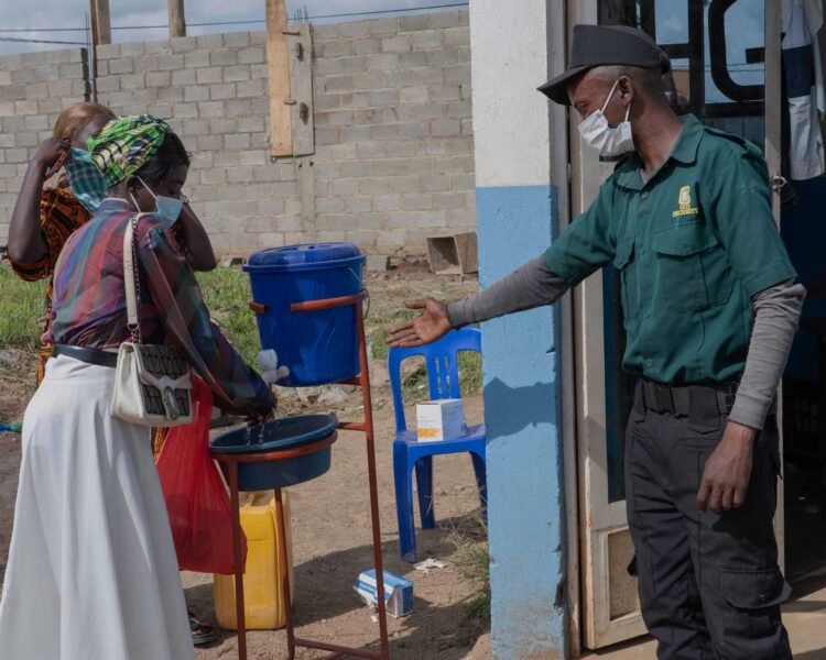 People-wash-their hands-at-the-entrance-to-a hospital-in-Bunia