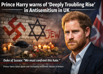 Prince Harry in a navy suit with a serious expression, standing against a blurred British flag backdrop. Beside him, a vandalized wall displays antisemitic graffiti including a swastika and Star of David, with candles and flowers forming a memorial below. This structure ensures the image and text are optimized for search engines while remaining accessible and engaging for readers. Would you like me to also suggest SEO keywords and meta tags to strengthen visibility for this headline?